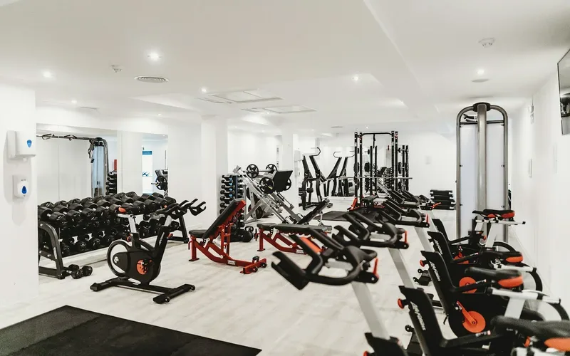 Fitness centre floor lined with cardio and weight equipment