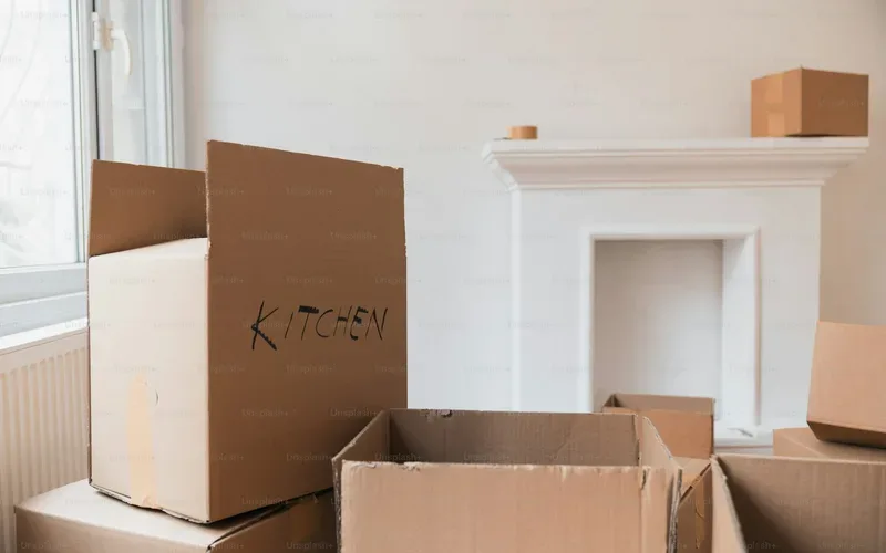 Packing boxes in an empty room being prepared for a move