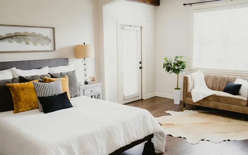 Freshly made bed in a bright vacation rental bedroom